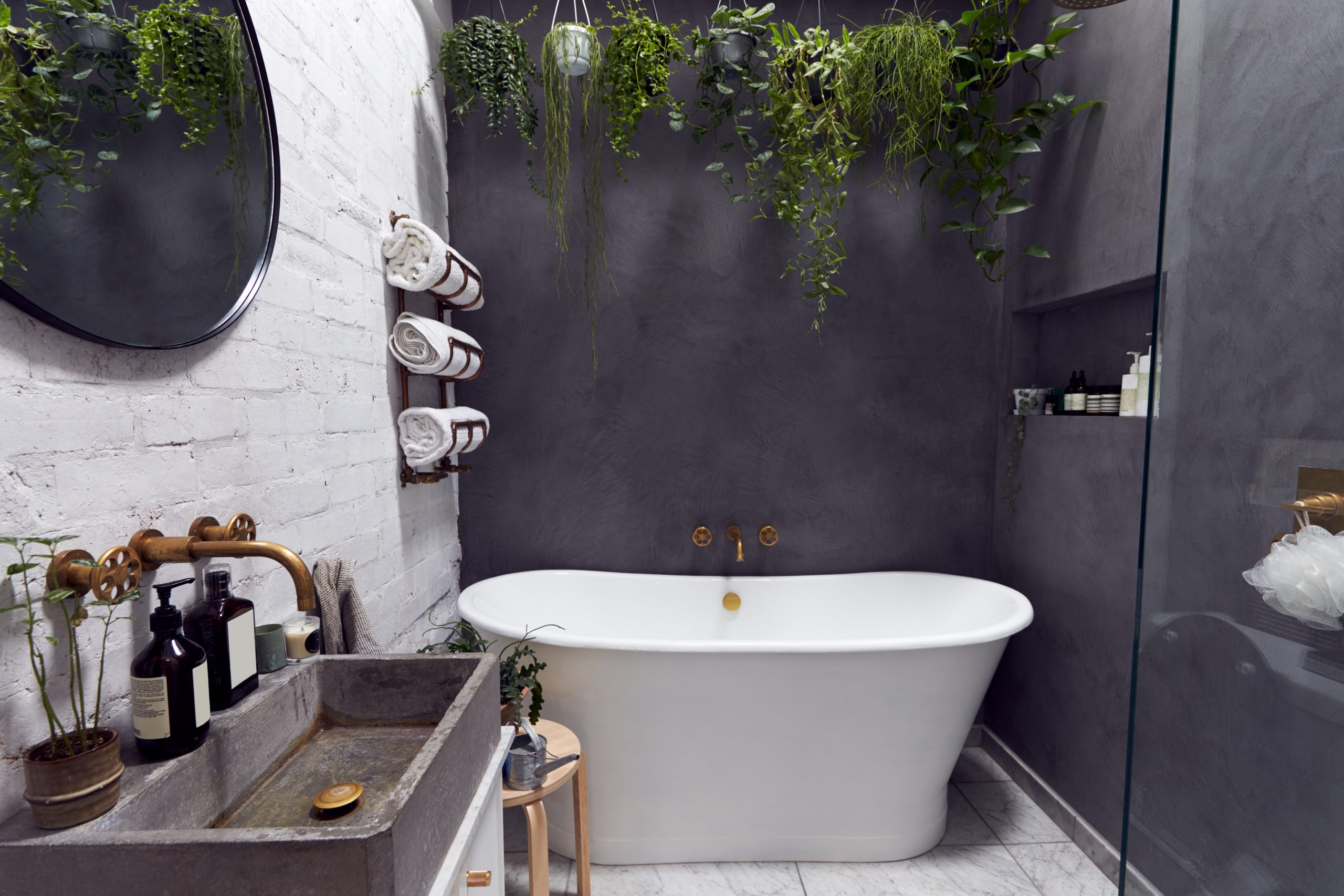 bathtub remodeling included slate walls, stonework, and free standing bath