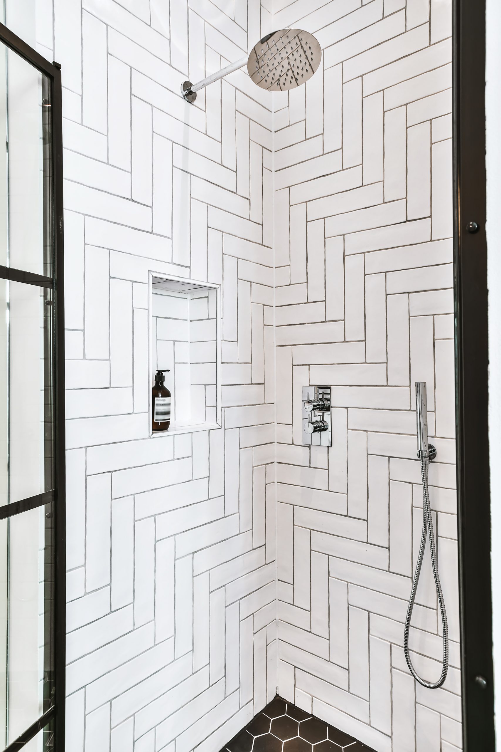 beautiful walk in shower with white tile walls