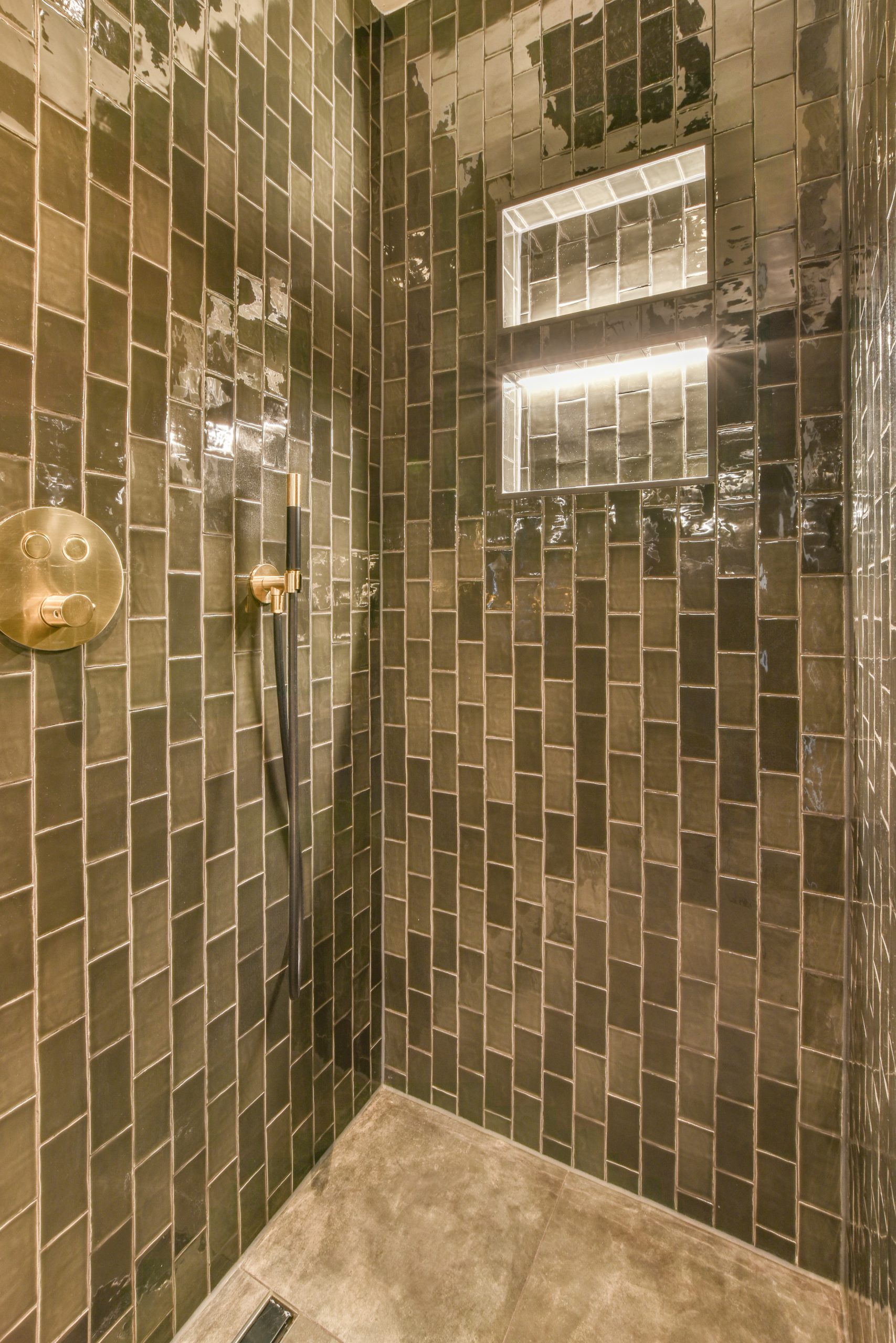 shower remodel with gorgeous green tiles and gold fixtures