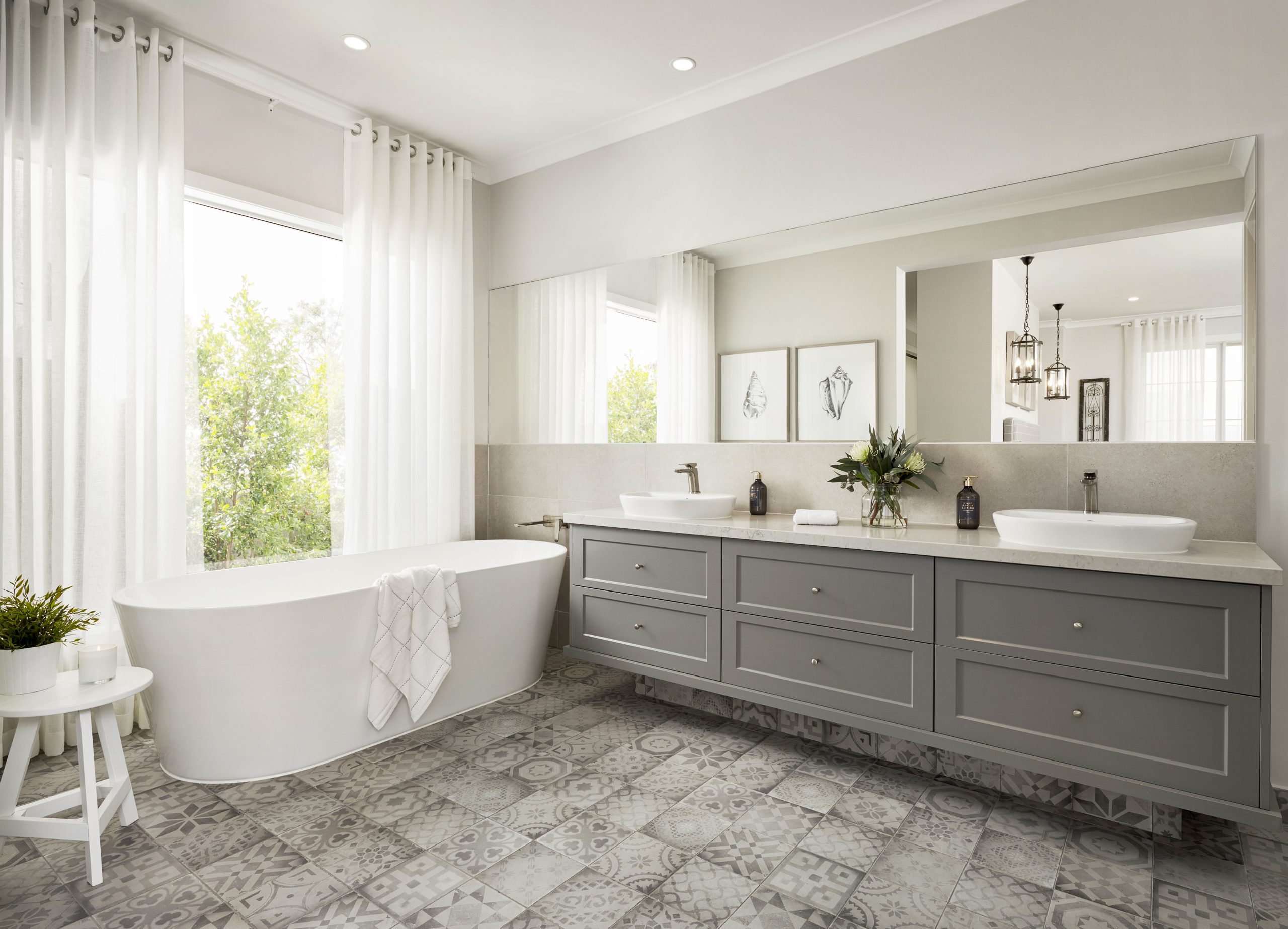 full bathroom remodel included grey double vanity, deep soaking tub, and flooring